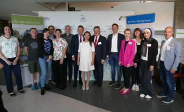 Gruppenfoto mit Mitwirkenden der Integrationsfachtagung vor Fotowand